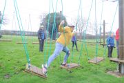 low level ropes course woman floating steps crossing