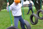 low level ropes course teenage girl tire swing crossing