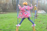 low level ropes course young girl log crossing